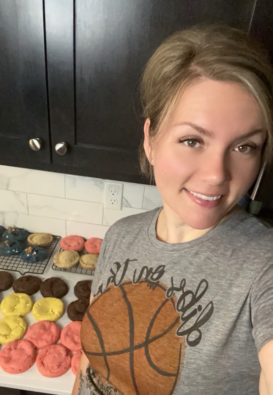 Chantel in her kitchen with a fresh batch of colorful cookies